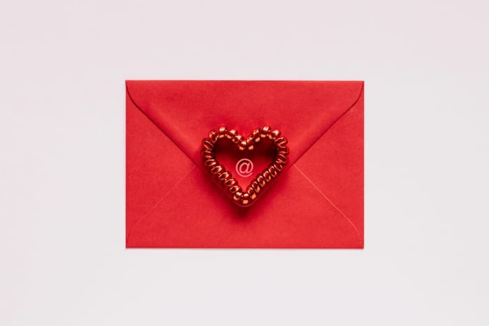 The back of a red envelope with a red heart in the middle.