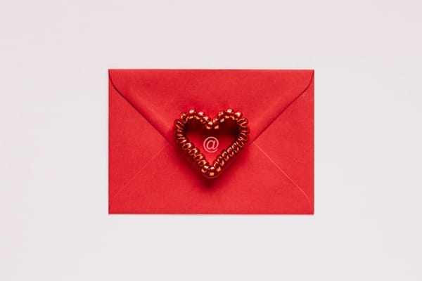 The back of a red envelope with a red heart in the middle.